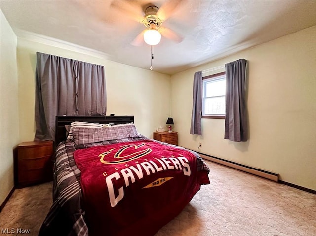 bedroom featuring light carpet, ceiling fan, and a baseboard heating unit