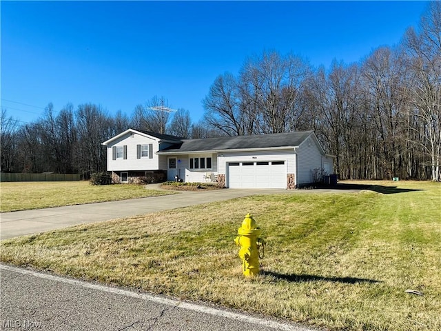 split level home with a garage and a front yard