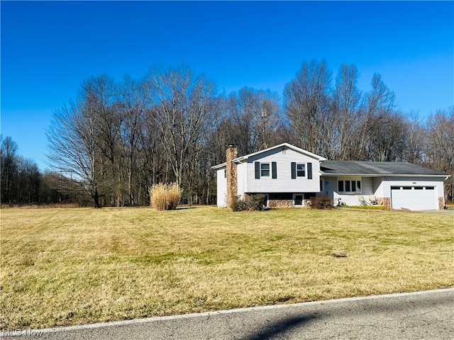 split level home with a front lawn and a garage