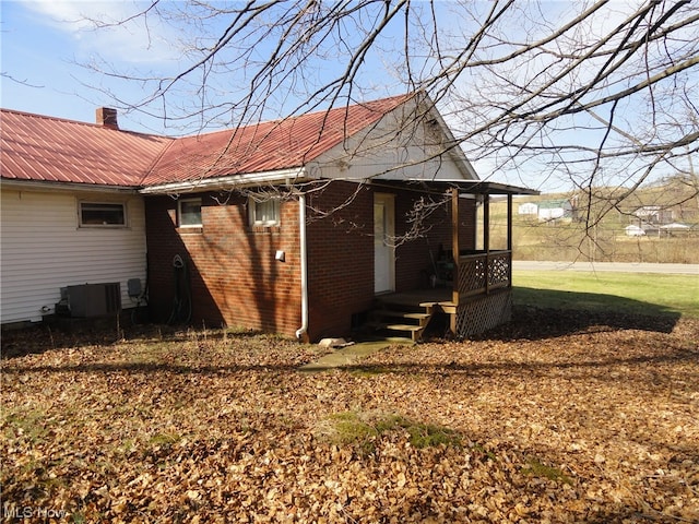 view of side of property featuring central AC