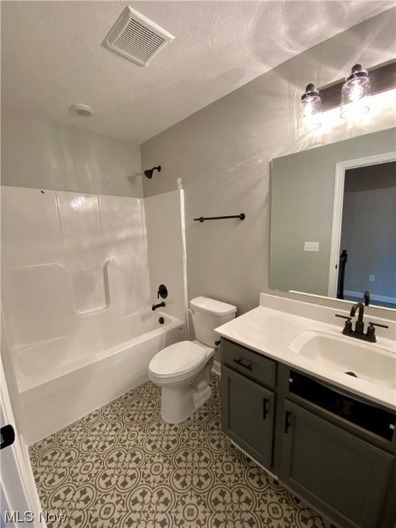 bathroom with shower / bathtub combination, toilet, vanity, visible vents, and tile patterned floors