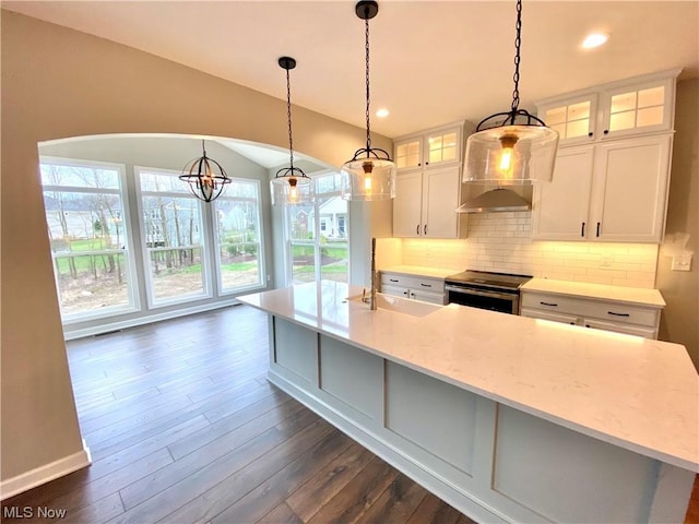 kitchen featuring pendant lighting, a sink, glass insert cabinets, and stainless steel range with electric cooktop