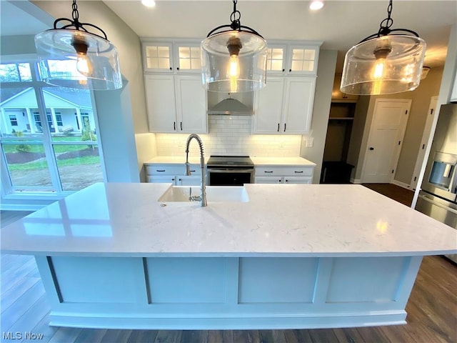 kitchen featuring stainless steel range with electric cooktop, glass insert cabinets, and pendant lighting