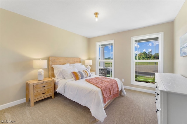 bedroom featuring light colored carpet