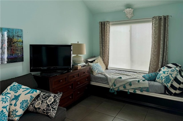 bedroom with vaulted ceiling and tile patterned flooring