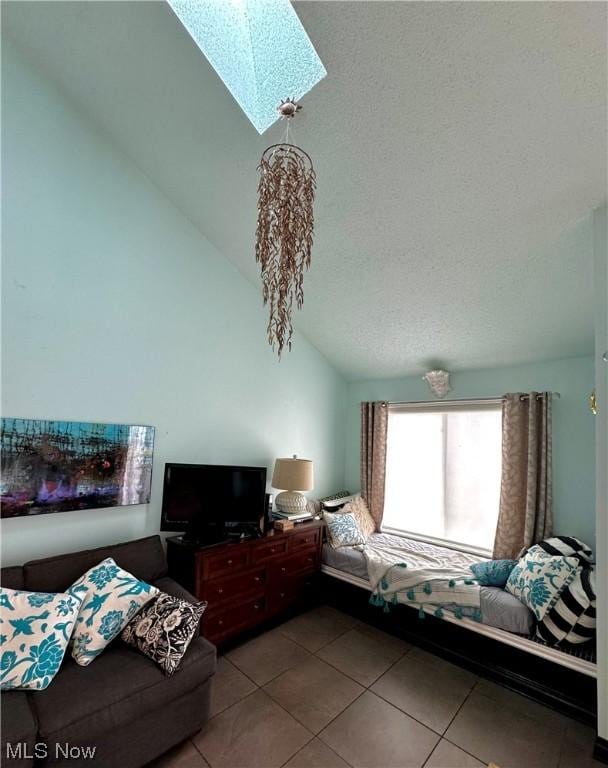 tiled bedroom with vaulted ceiling with skylight