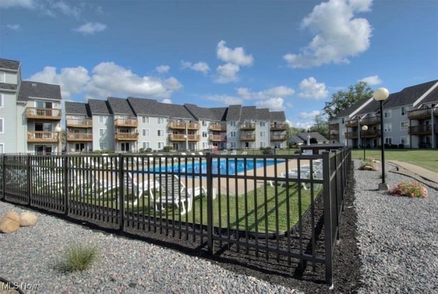 view of gate with fence and a residential view