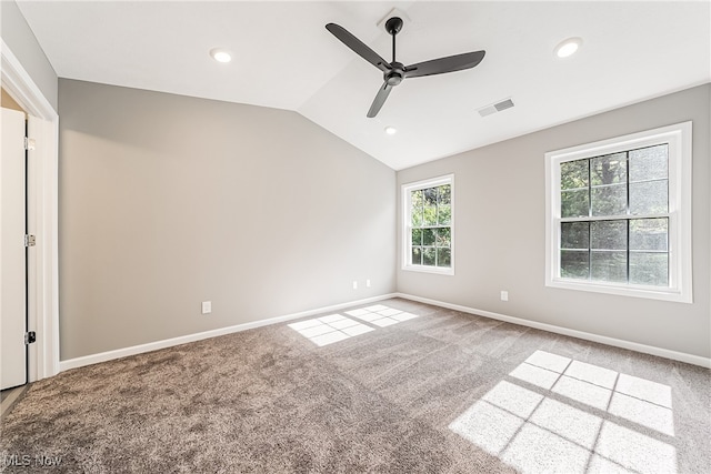 carpeted spare room with vaulted ceiling and ceiling fan