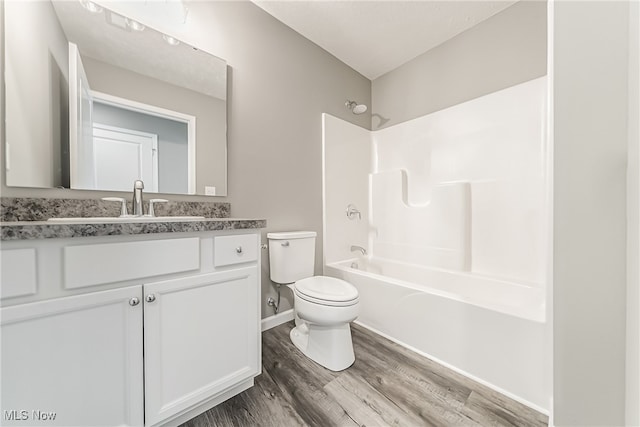 full bathroom featuring vanity, wood-type flooring, shower / bathing tub combination, and toilet