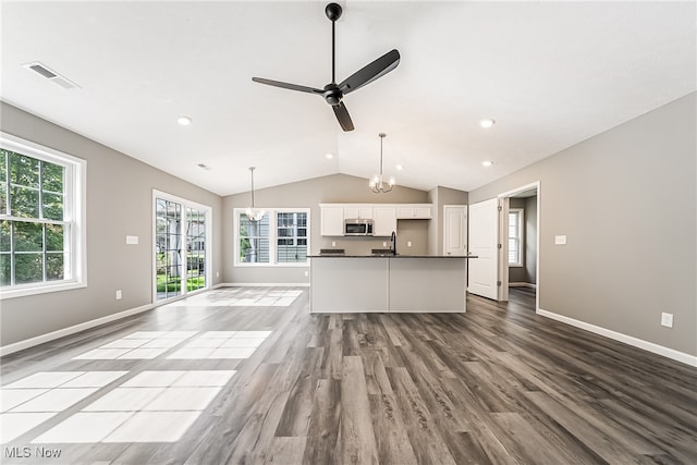 unfurnished living room with sink, vaulted ceiling, light hardwood / wood-style flooring, and ceiling fan with notable chandelier