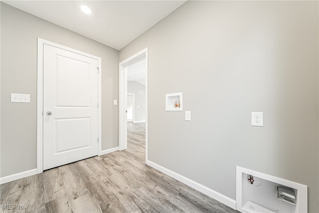 laundry area featuring hookup for a washing machine and light hardwood / wood-style flooring