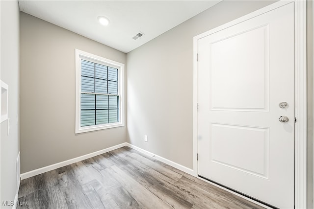 unfurnished room with light hardwood / wood-style floors