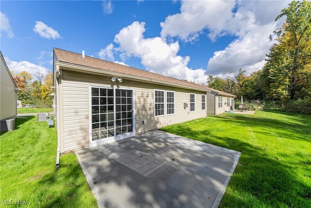 rear view of house with a yard and a patio area