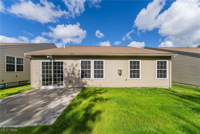 back of house featuring a patio area and a lawn