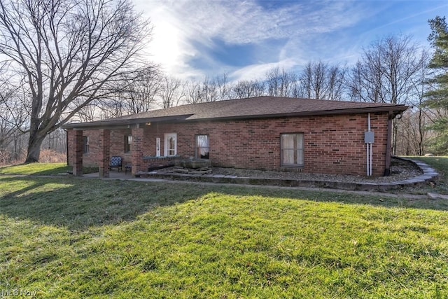 back of house featuring a lawn and a patio