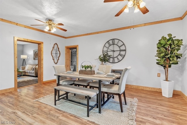 dining room featuring light hardwood / wood-style floors, ceiling fan, and crown molding