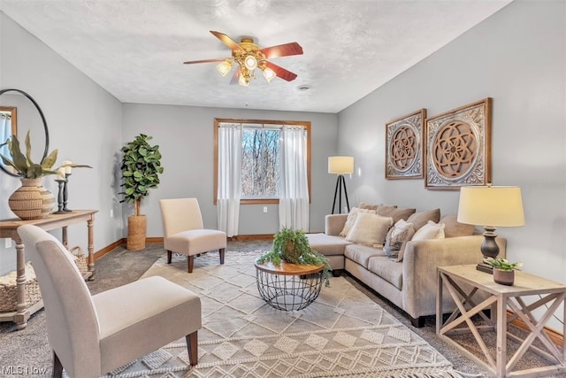 carpeted living room with a textured ceiling and ceiling fan