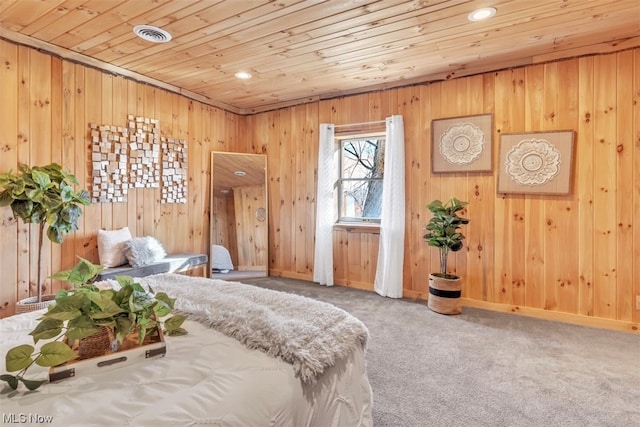 bedroom with wooden walls, light colored carpet, and wood ceiling