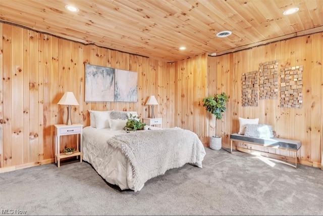 bedroom with wooden walls, light colored carpet, and wood ceiling