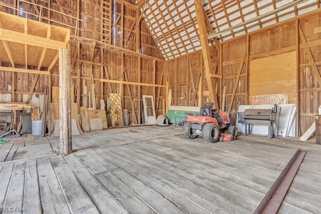 miscellaneous room featuring light hardwood / wood-style floors and high vaulted ceiling