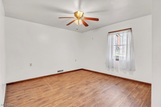 empty room with ceiling fan and hardwood / wood-style floors