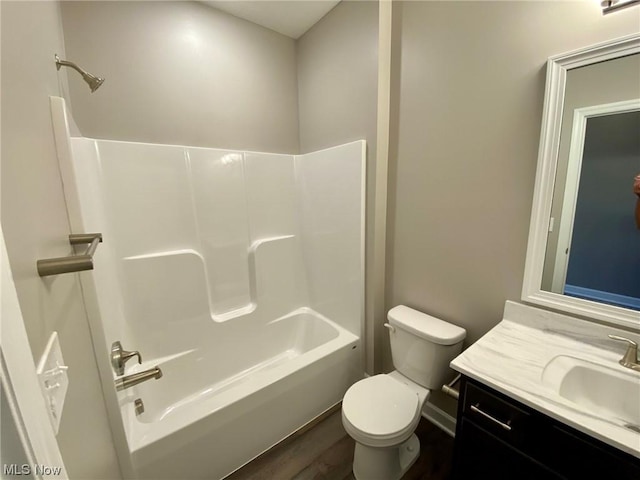 full bathroom with vanity, wood-type flooring, toilet, and shower / bathing tub combination