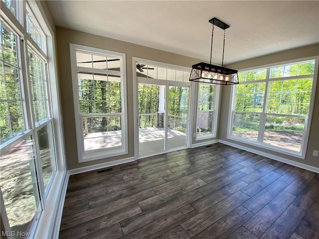 unfurnished dining area with dark hardwood / wood-style flooring