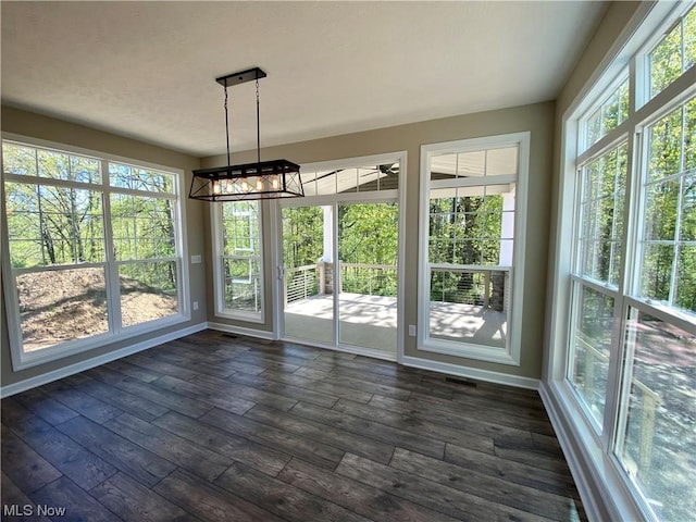 2439 Ledgestone Dr NW, Uniontown, OH 44685 - unfurnished sunroom featuring a chandelier, baseboards, and wood finished floors