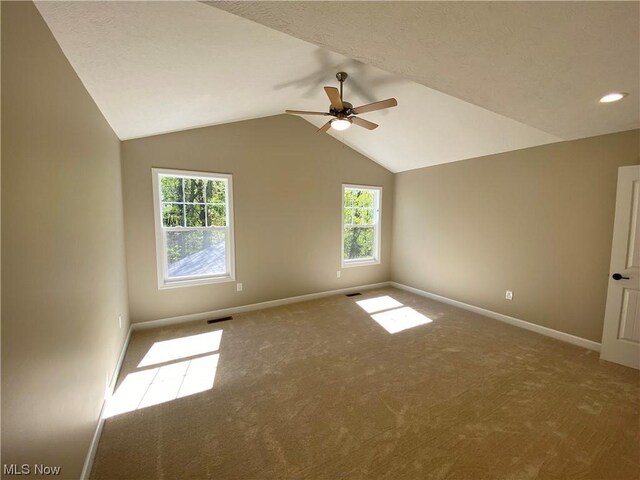 2439 Ledgestone Dr NW, Uniontown, OH 44685 - carpeted spare room with a ceiling fan, baseboards, healthy amount of natural light, vaulted ceiling, and recessed lighting