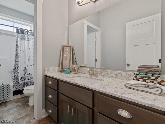 bathroom featuring toilet, shower / bath combo, and vanity