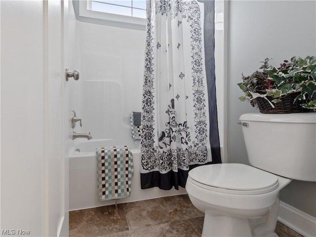 full bath with toilet and shower / bath combo with shower curtain