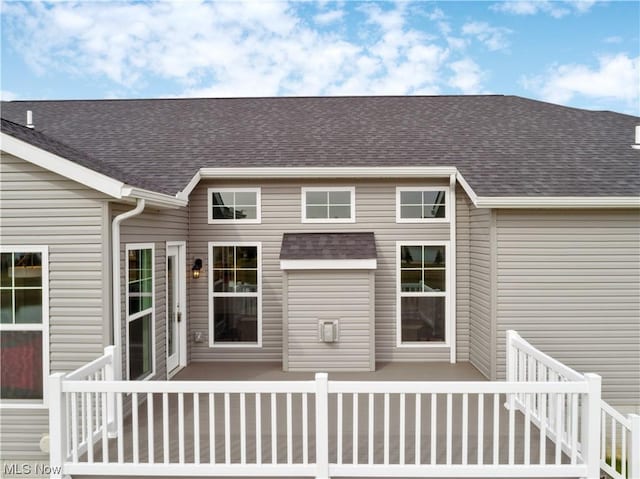 exterior space with roof with shingles