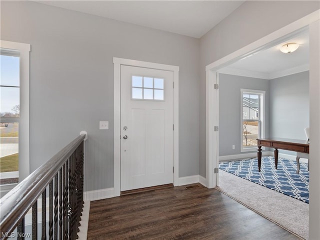 foyer entrance with baseboards and dark wood finished floors