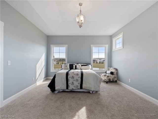 bedroom featuring carpet floors, an inviting chandelier, and baseboards