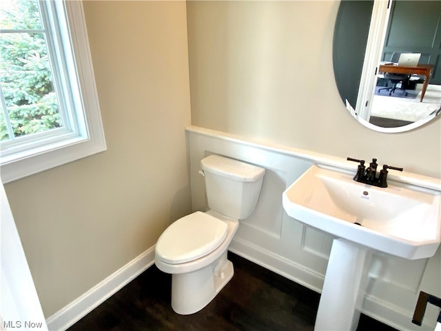 bathroom with hardwood / wood-style flooring, sink, and toilet