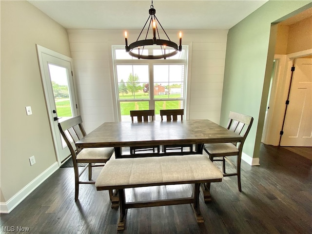 dining area with an inviting chandelier and dark hardwood / wood-style flooring