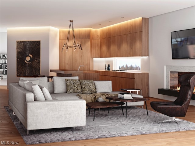 living room with light hardwood / wood-style flooring and an inviting chandelier