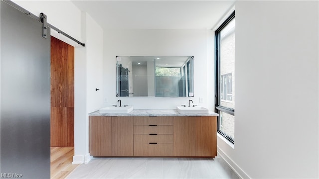 bathroom featuring dual vanity, tile floors, and a wealth of natural light