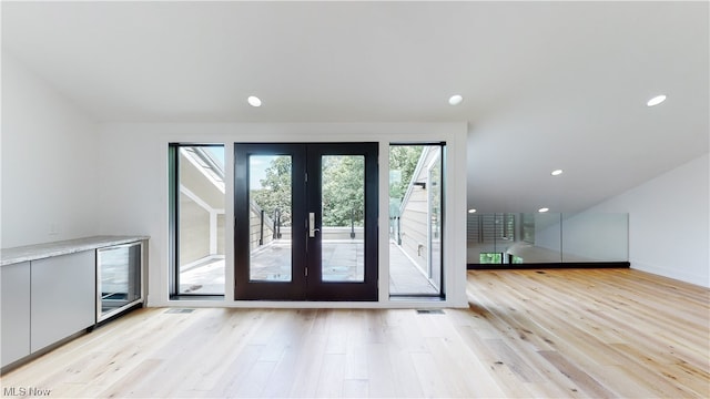 entryway featuring light hardwood / wood-style flooring and french doors