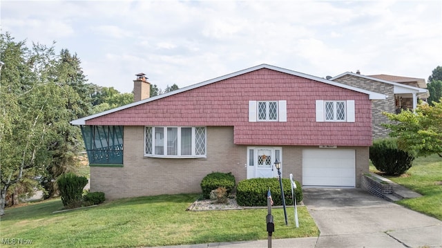 split level home featuring a garage and a front yard