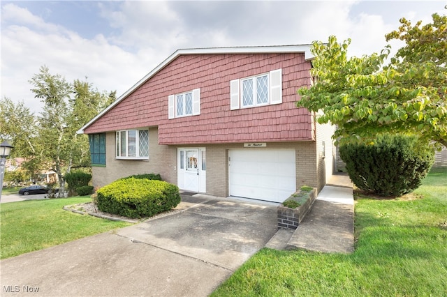 view of front of home featuring a garage and a front lawn