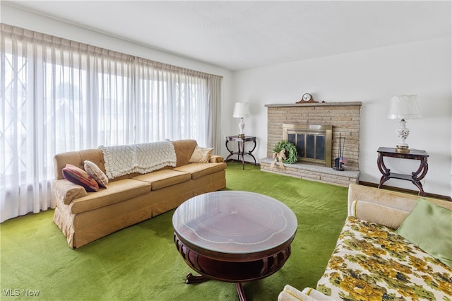 carpeted living room with a stone fireplace and a healthy amount of sunlight