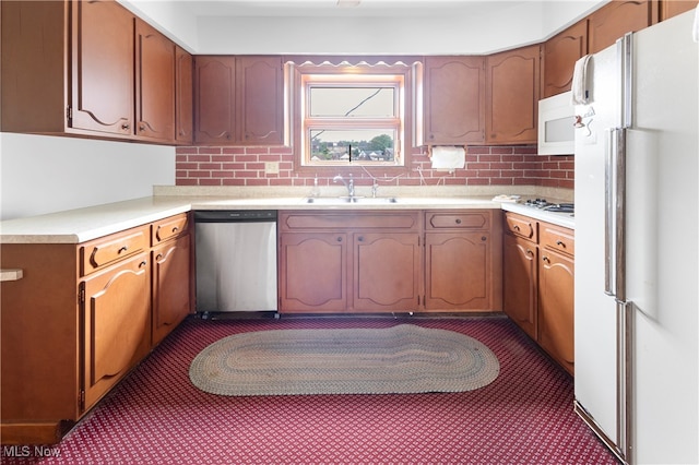 kitchen with white appliances, sink, and decorative backsplash