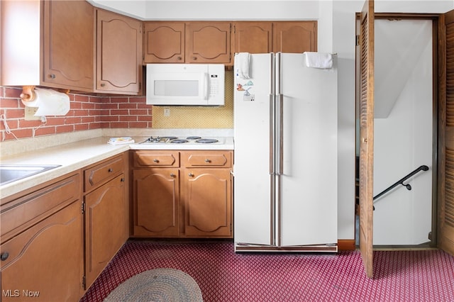 kitchen with white appliances and tasteful backsplash