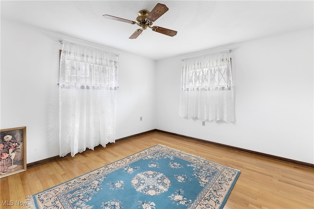 empty room with ceiling fan and light wood-type flooring