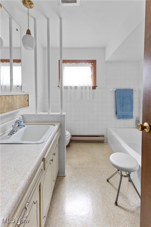 bathroom with toilet, vanity, backsplash, a washtub, and tile walls