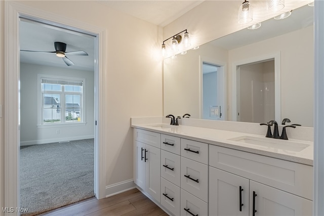 bathroom featuring wood-type flooring, ceiling fan, and vanity