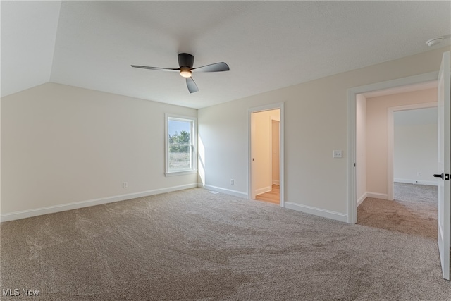 unfurnished bedroom with light carpet, lofted ceiling, and ceiling fan