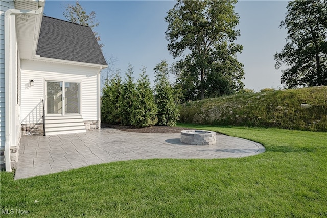 view of yard featuring a fire pit and a patio area