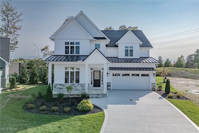 modern farmhouse style home featuring a porch, a garage, and a front yard